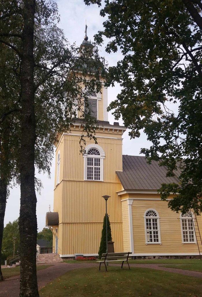 Peltoaukion eteläreunalla on kirkonkylän tornillinen ristikirkko hautausmaineen. Wiki Loves Monuments, CC BY-SA 4.0 JoeK 2018
